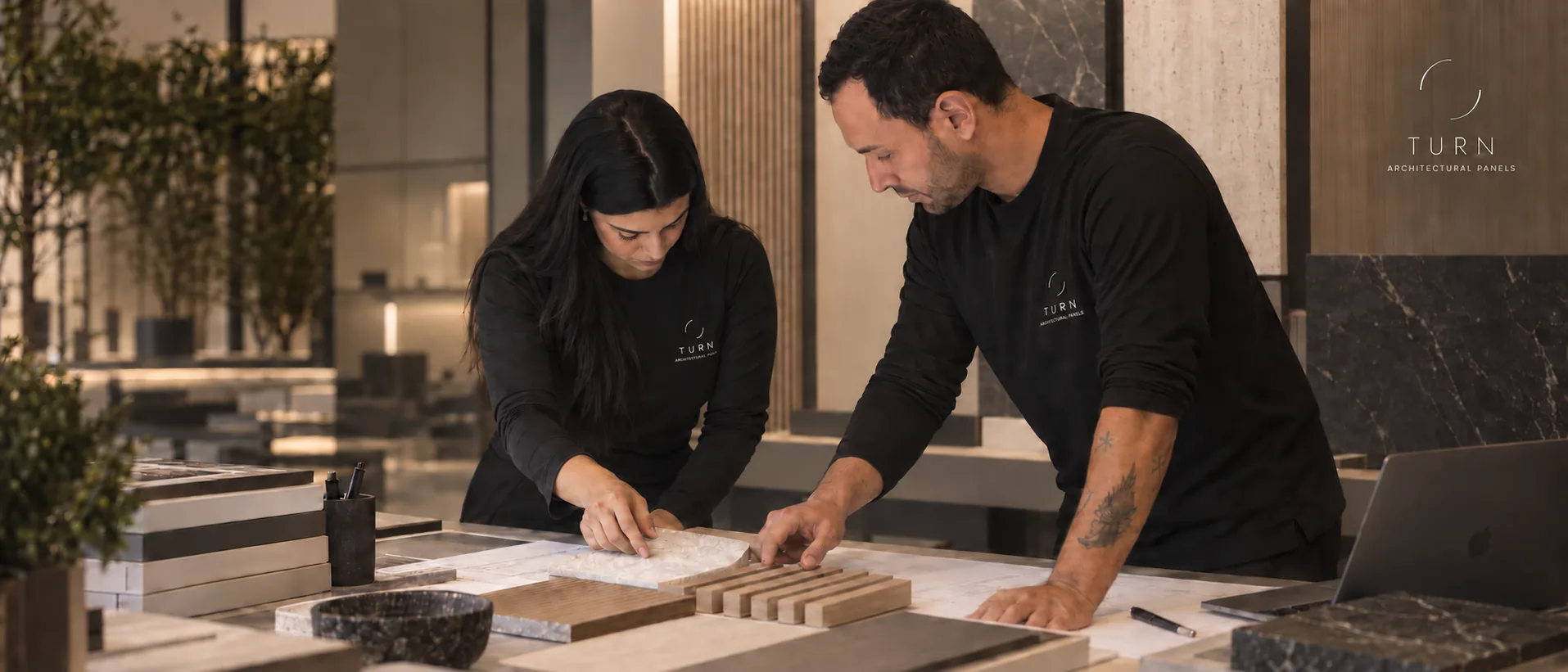 Beatriz Pires and Matheus Prestes reviewing material samples for a TURN project